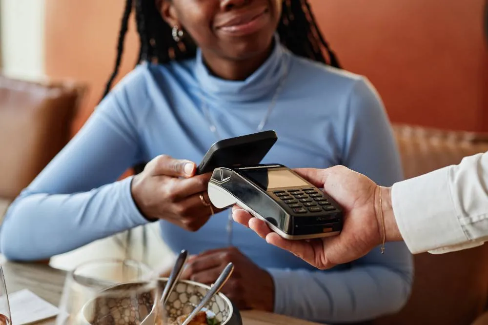 Young Adult Black Woman Paying Restaurant Bill